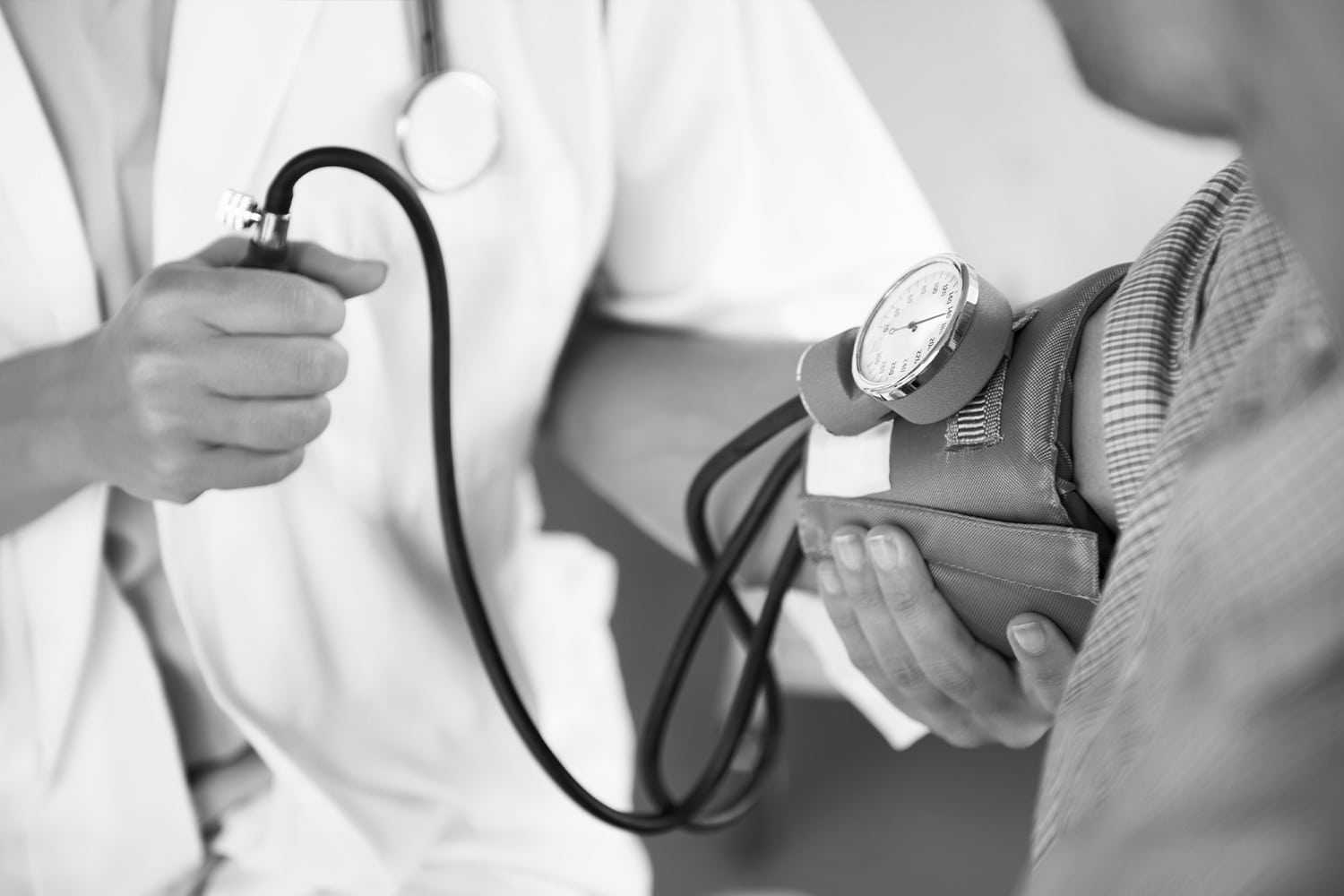 Doctor checking a patient's blood pressure