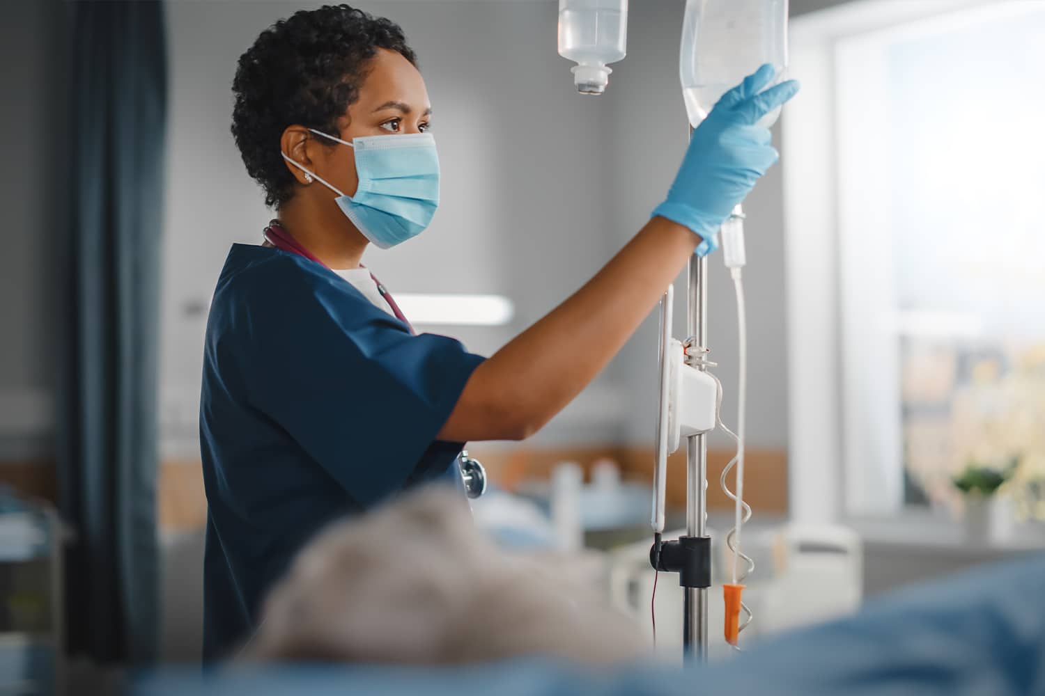 Nurse checking a patient's IV bag